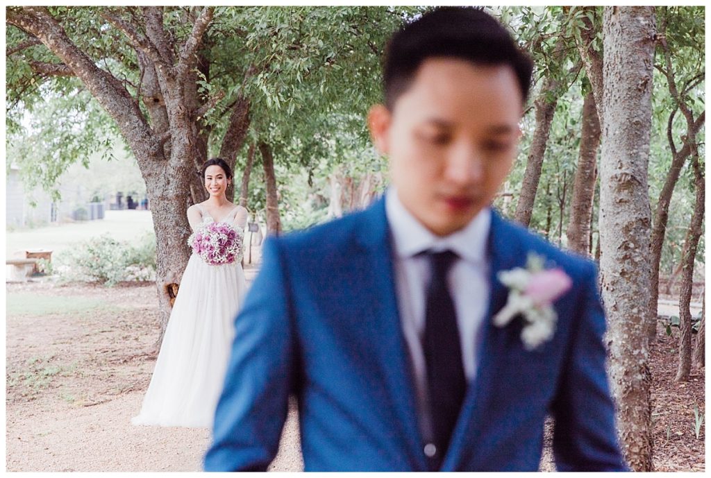 Bride walking up behind groom for first look at Stonebridge Wedding Venue photographed by Picture Bouquet Studio. 