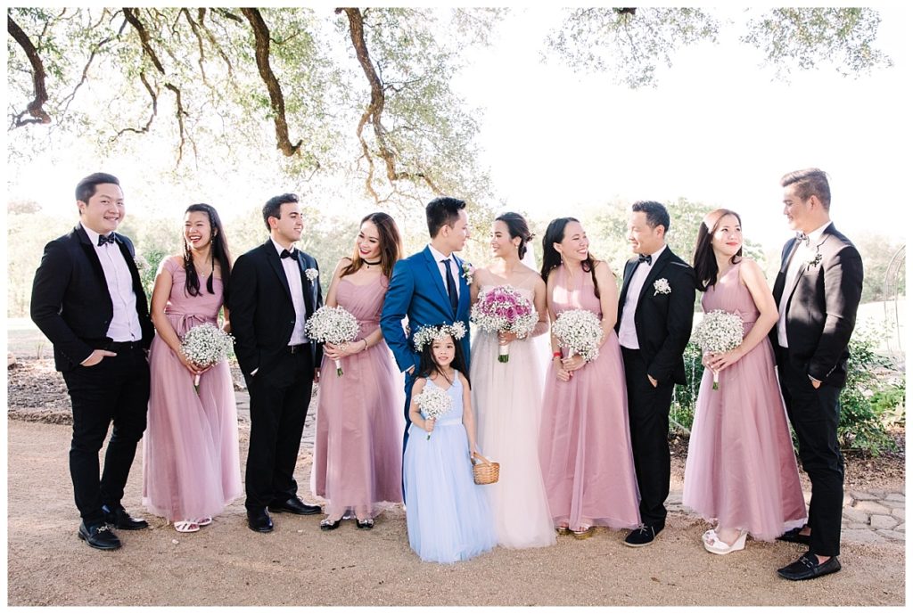 Bride and groom poses with bridal party and flower girl for outdoor wedding at Stonebridge Wedding Venue photographed by Dallas wedding photographer Picture Bouquet Studio. 