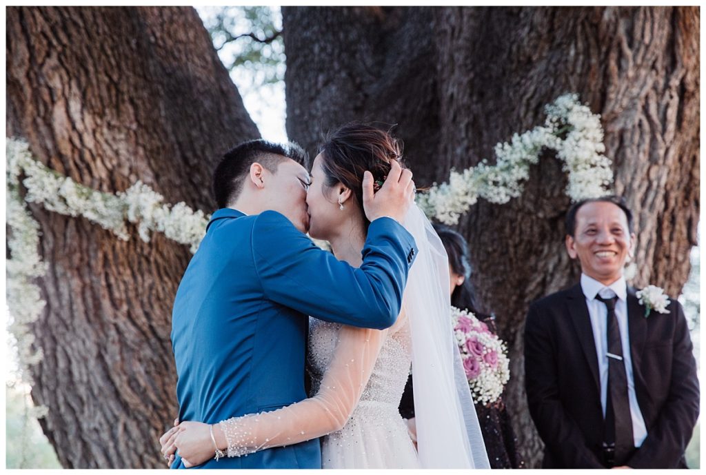 The kiss during the outdoor wedding ceremony at Stonebridge photographed by Dallas wedding photographer Picture Bouquet Studio. 