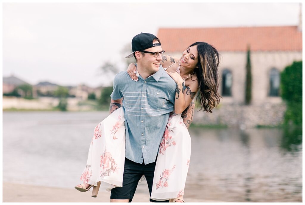 Fun pose of guy carrying fiancee on back for an Adriatica Village engagement session photographed by Picture Bouquet Studio in Mckinney, TX. 