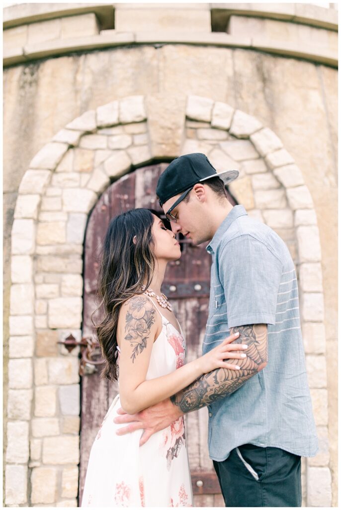 Engaged couple poses with eyes close in intimate moment in front of castle for  an Adriatica Village engagement session photographed by Picture Bouquet Studio. 