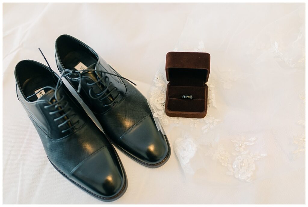 Groom's black shoes and black wedding band close up photographed by Dallas wedding photographer, Jenny Bui of Picture Bouquet Studio. 