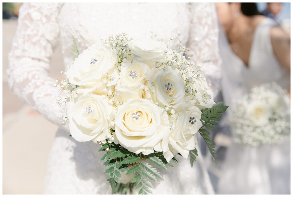 Close up of white rose bouquet during first look at Flower Mound River Walk photographed by Dallas wedding photographer, Jenny Bui of Picture Bouquet Studio.  