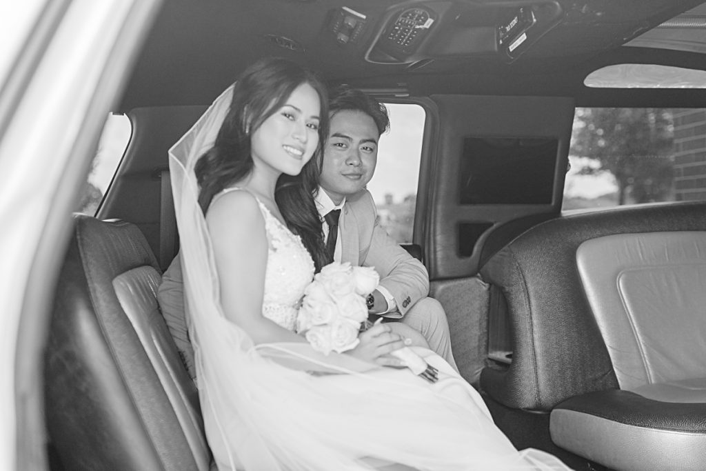 Bride and groom inside white limousine photographed by Picture Bouquet Studio. 