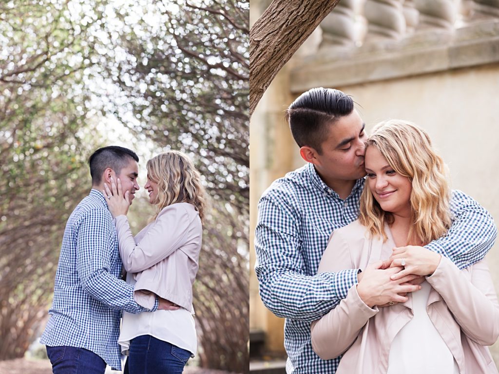 Young man in blue and white gingham shirt holds fiancee in pastel pink jacket under the tree walkway at the Dallas Arboretum in left photo and hugs fiancee from behind in right photo photographed by Dallas Wedding Photographer Jenny Bui of Picture Bouquet Studio. 