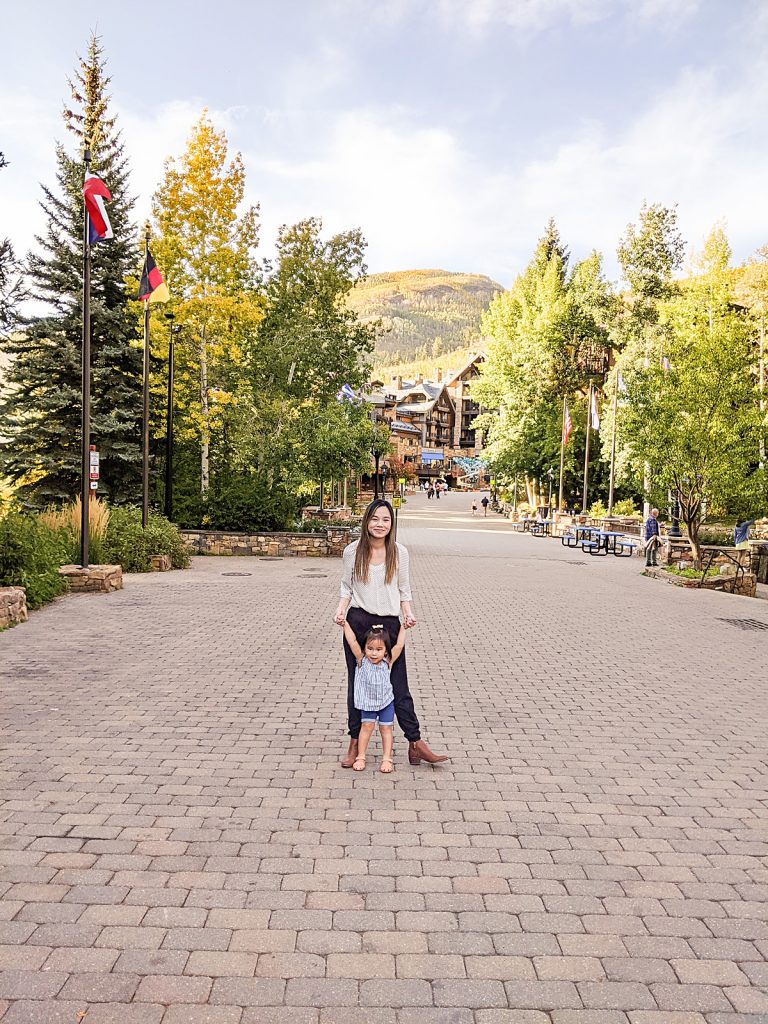 Photo of mom and daughter in Vail Village, Colorado during the fall foliage. 