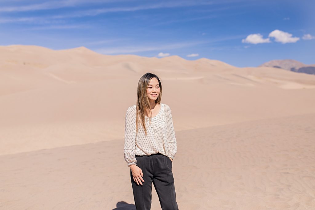 Photo of travel blogger at Great Sand Dunes National Park. 