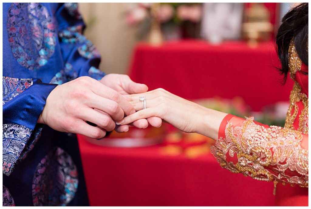 Close up of ring exchange during traditional Vietnamese tea ceremony photographed by Dallas wedding photographer Jenny Bui of Picture Bouquet Studio. 