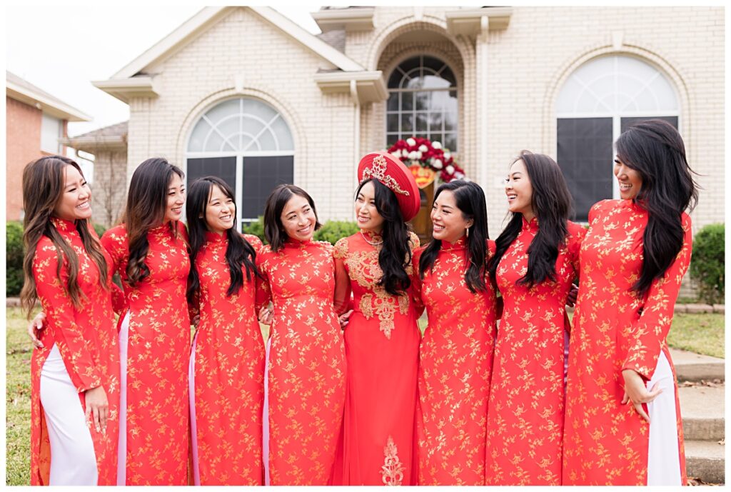 Beautiful bride in red and gold ao dai with her bridesmaids during Vietnamese tea ceremony in Dallas photographed by Picture Bouquet Studio. 