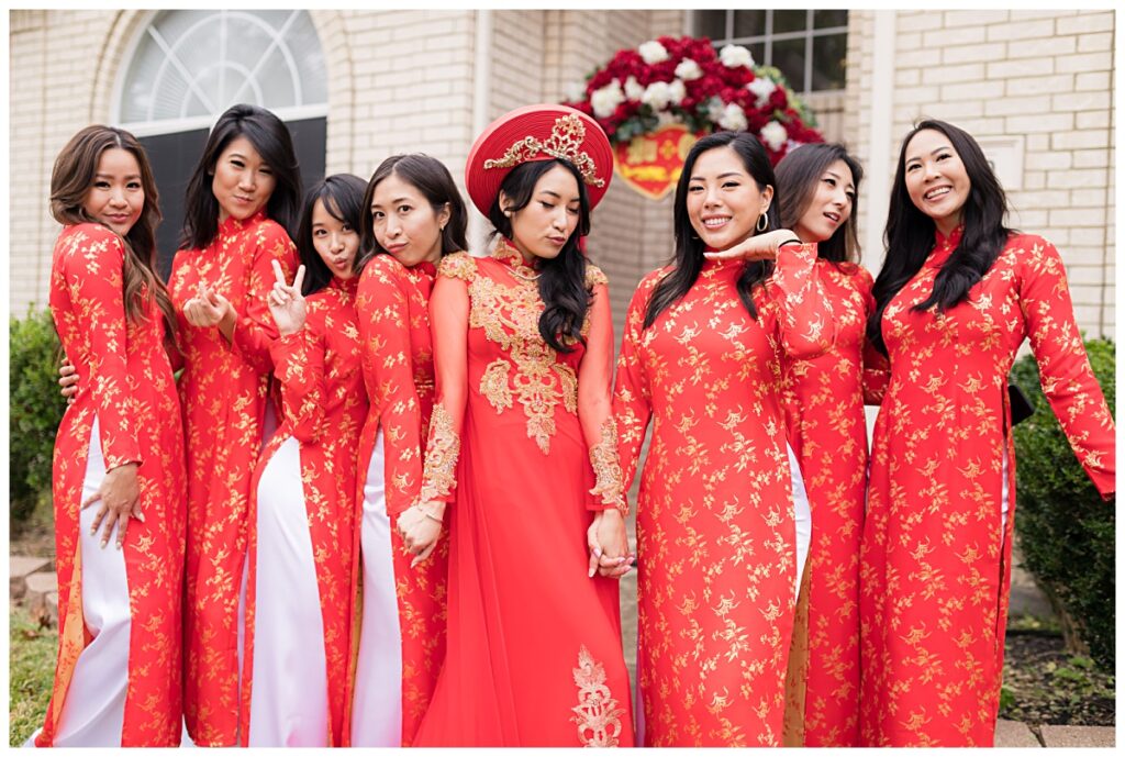 Bride posing with bridesmaids in beautiful red and gold ao dais for Dallas Vietnamese tea ceremony photographed by Jenny Bui of Picture Bouquet Studio. 