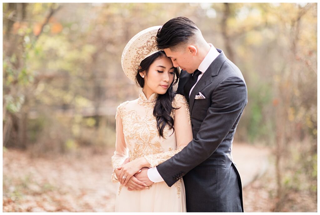 Groom holding bride in yellow ao dai close during Prairie creek portrait session photographed by Dallas wedding photographer Jenny Bui of Picture Bouquet Studio. 