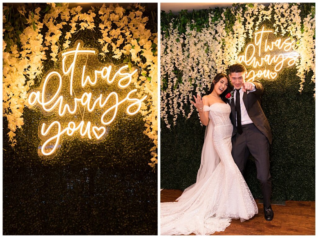 Bride in beautiful off-shoulder wedding dress and groom in grey suit poses in front of backdrop for Kirin Court wedding photographed by Dallas Wedding Photographer Jenny Bui of Picture Bouquet Studio. 