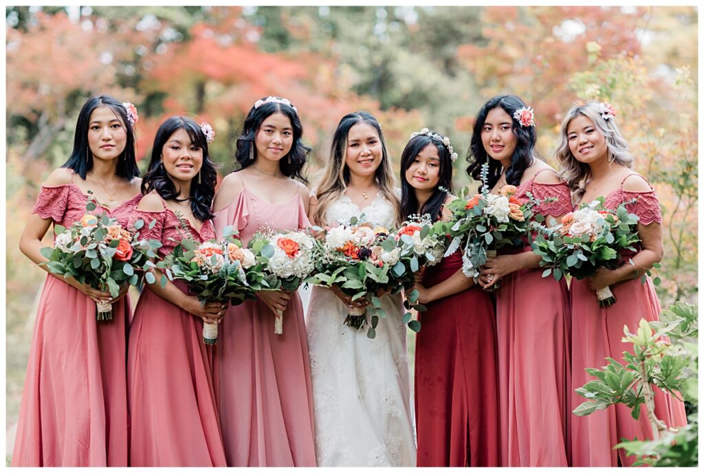 Bridesmaids in dusty rose maxi dresses poses with bride at Fort Worth Japanese Garden photographed by Jenny Bui of Picture Bouquet Studio. 