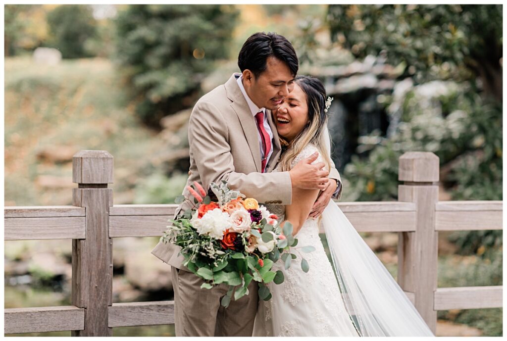 Groom hugging bride during first look at Fort Worth Japanese Garden photographed by Jenny Bui of Picture Bouquet Studio. 