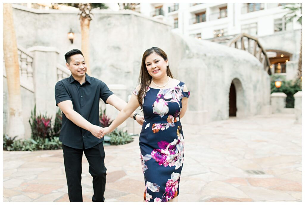 Girl pulling fiance's hand for Gaylord engagement session photographed by Dallas wedding photographer Jenny Bui of Picture Bouquet Studio. 