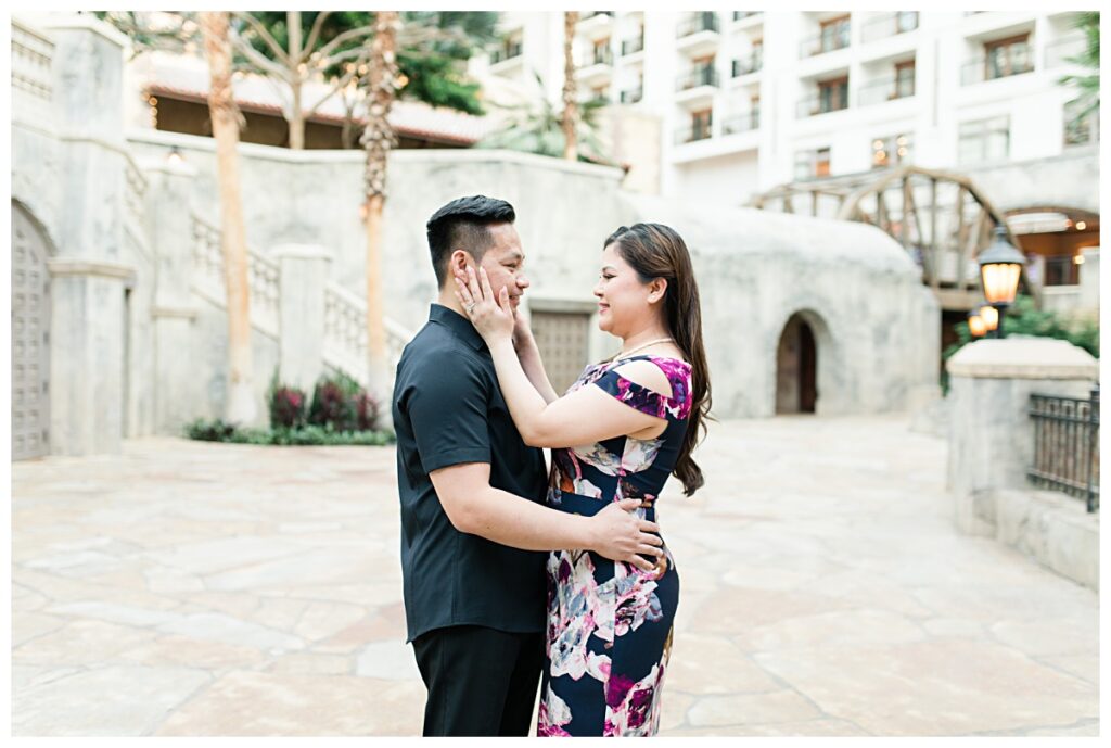 Girl caressing fiance's face for Gaylord Texan Resort engagement session photographed by Dallas wedding photographer Jenny Bui of Picture Bouquet Studio. 
