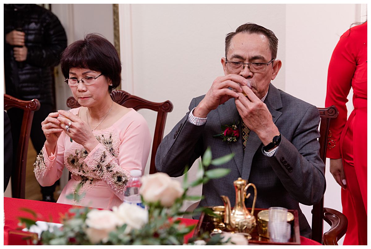 Parents of the groom drinking tea during Dallas Vietnamese tea ceremony photographed by Jenny Bui of Picture Bouquet Studio. 