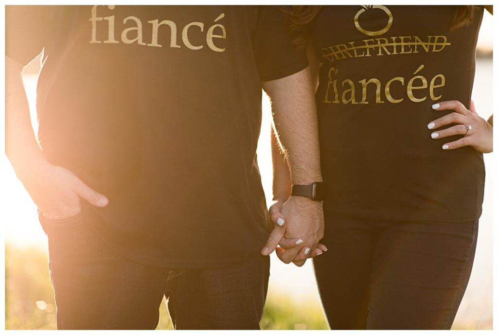 Close up of engaged couple holding hands with matching black tees during engagement session photographed by Dallas wedding photographer Jenny Bui of Picture Bouquet Studio. 