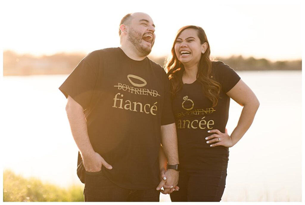 Engaged couple laughing during Ennis bluebonnet engagement session at sunset photographed by Dallas wedding photographer Jenny Bui of Picture Bouquet Studio. 