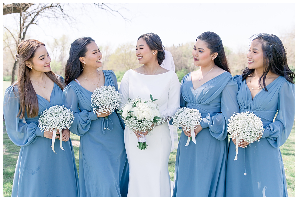Bridesmaids in long sleeve light blue silk dresses smiling with bride for a Dallas Asian wedding photographed by Jenny Bui of Picture Bouquet Studio. 