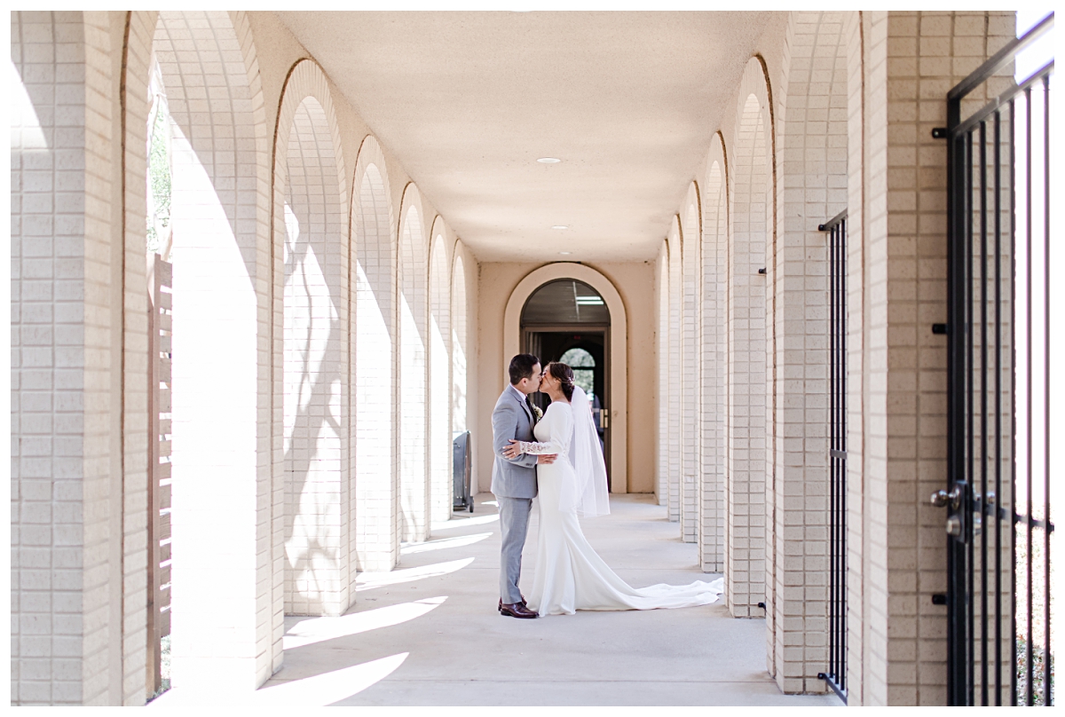 Bride and groom kissing at Highland Oaks Church of Christ for wedding portraits from a Dallas Asian wedding photographed by Jenny Bui of Picture Bouquet Studio. 