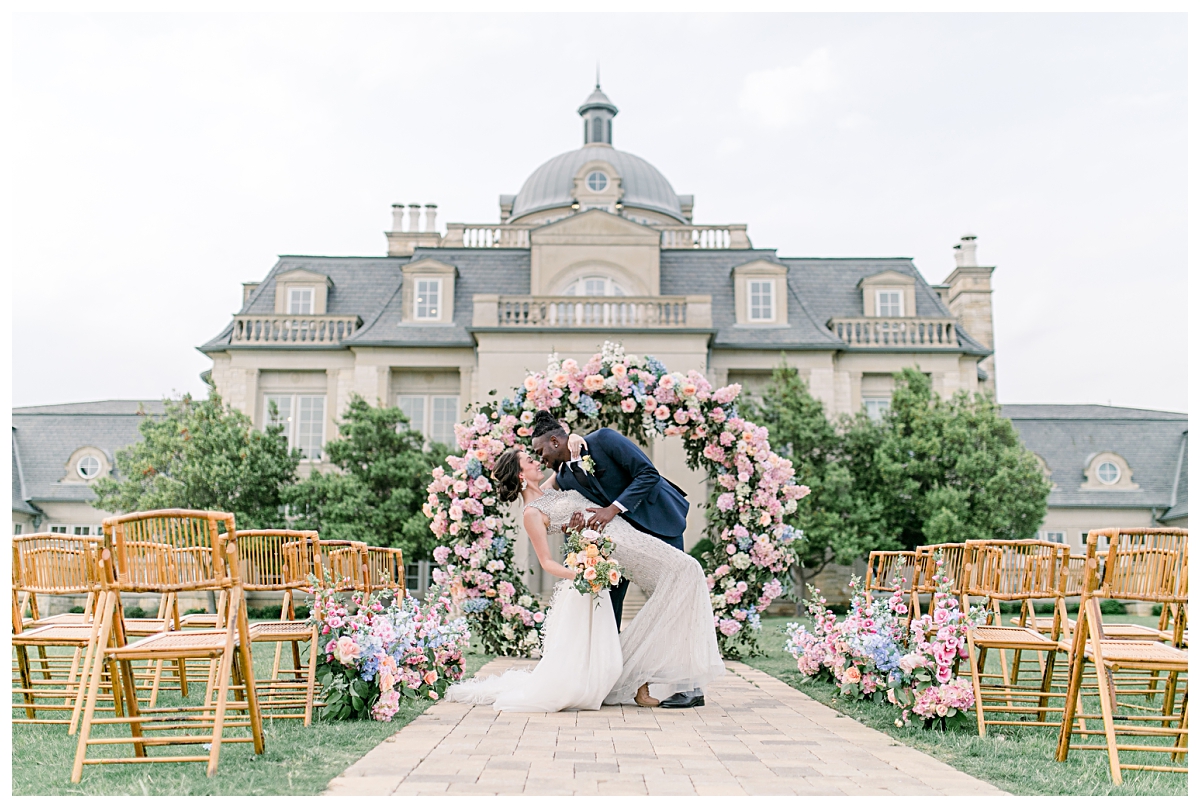 Groom dipping bride in front of The Olana Wedding Venue for styled shoot photographed by Dallas Wedding Photographer Jenny Bui of Picture Bouquet Studio. 