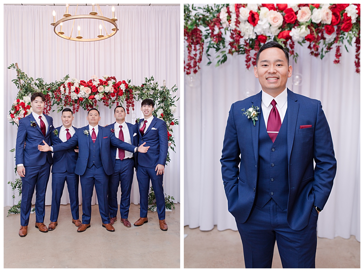 Groomsmen posing with groom in front of red and peach roses floral display at Zander House wedding photographed by Dallas wedding photographer Jenny Bui of Picture Bouquet Studio. 