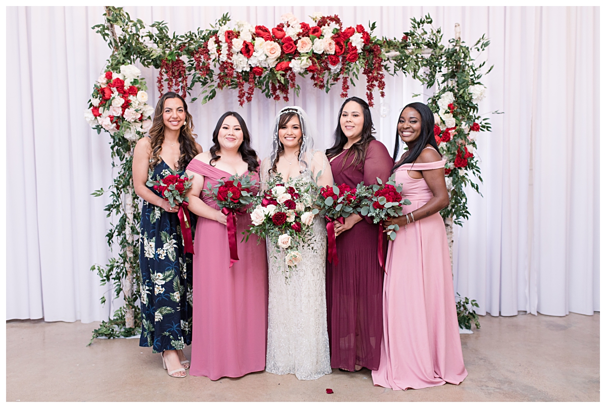 Bride in beaded vintage wedding dress poses with bridesmaid at Zander House wedding photographed by Dallas wedding photographer Jenny Bui of Picture Bouquet Studio. 