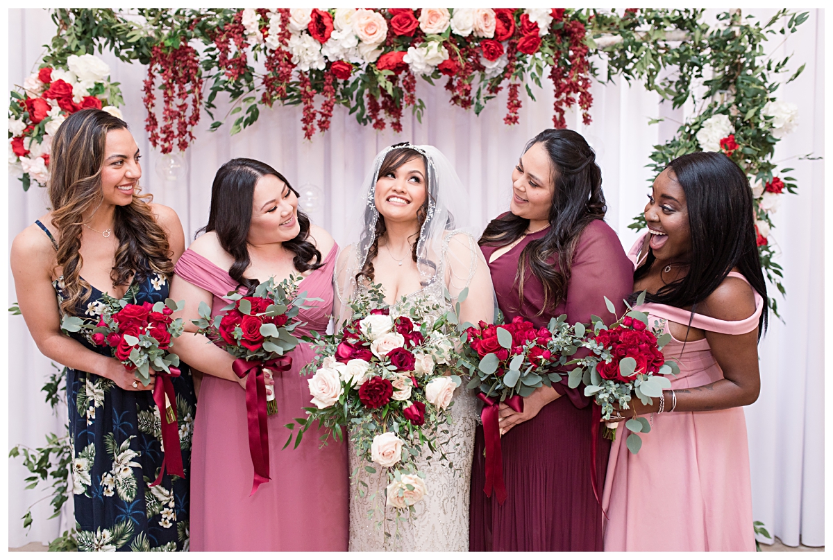Bridesmaid laughing and looking at beautiful bride in vintage beaded wedding dress at Zander House wedding photographed by Dallas wedding photographer Jenny Bui of Picture Bouquet Studio. 