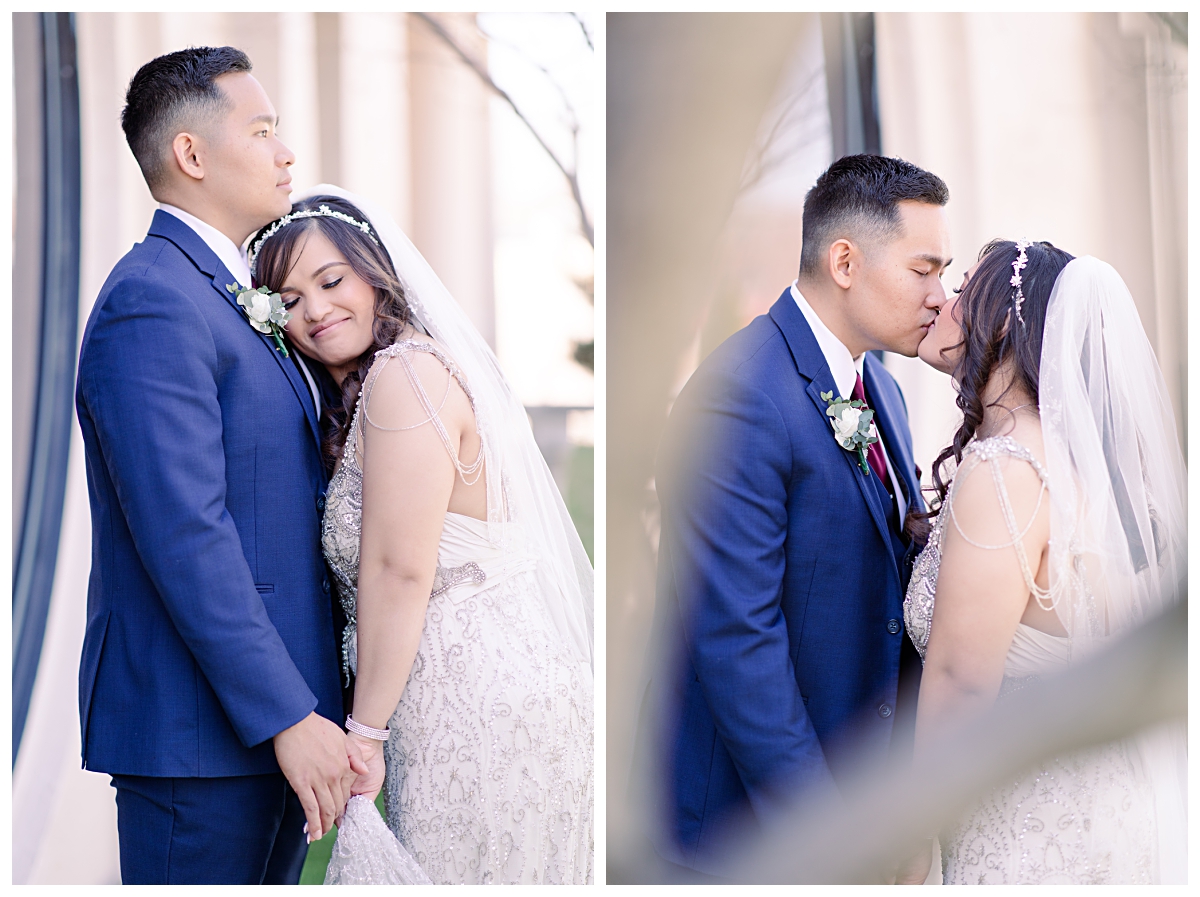 Bride in vintage wedding dress and groom in navy suit and burgundy tie enbrace and kiss during portrait session during Dallas Vietnamese wedding at Zander House photographed by Dallas wedding photographer Jenny Bui of Picture Bouquet Studio. 