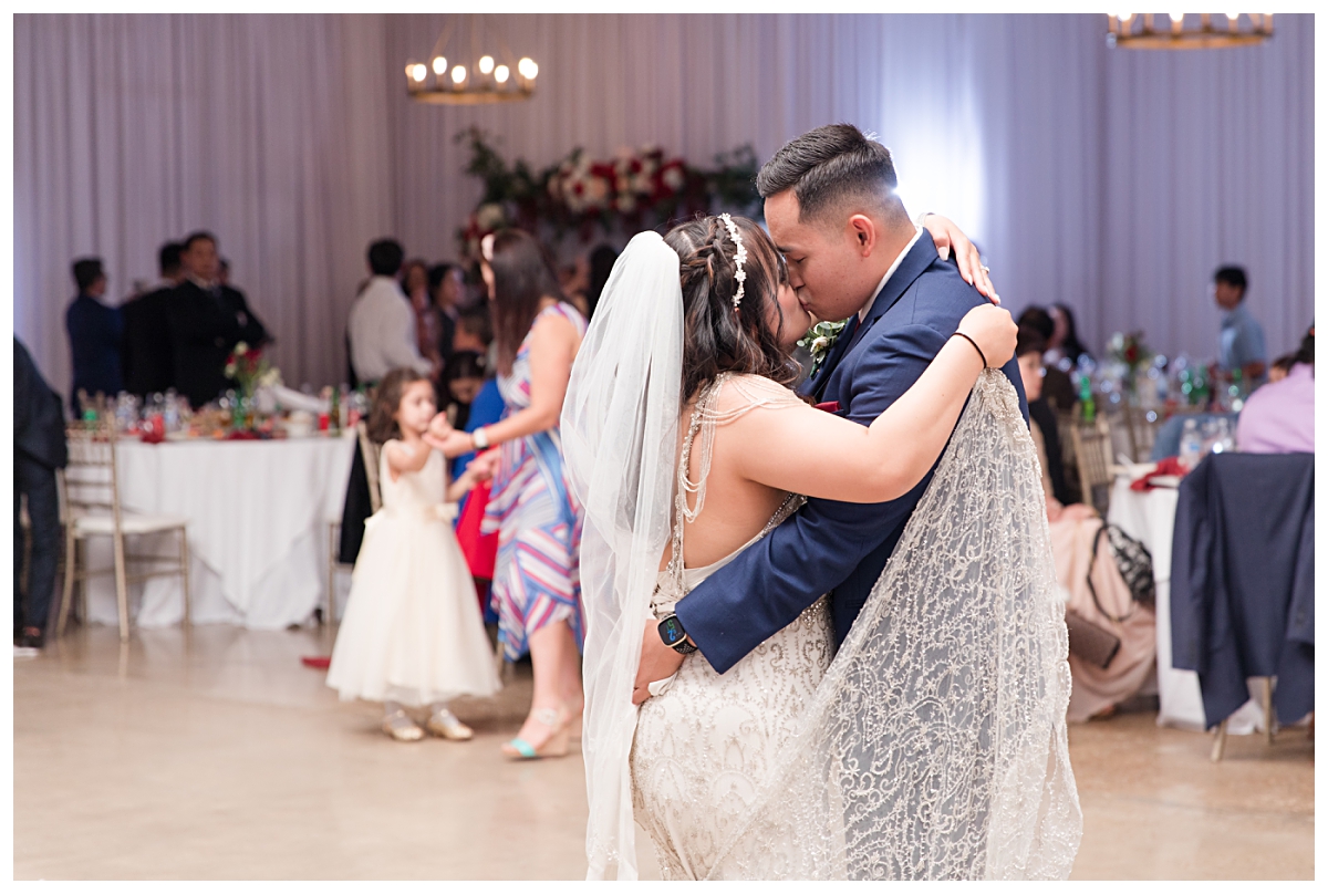 Bride and groom shares sweet kiss at Zander House wedding photographed by Dallas wedding photographer Jenny Bui of Picture Bouquet Studio. 