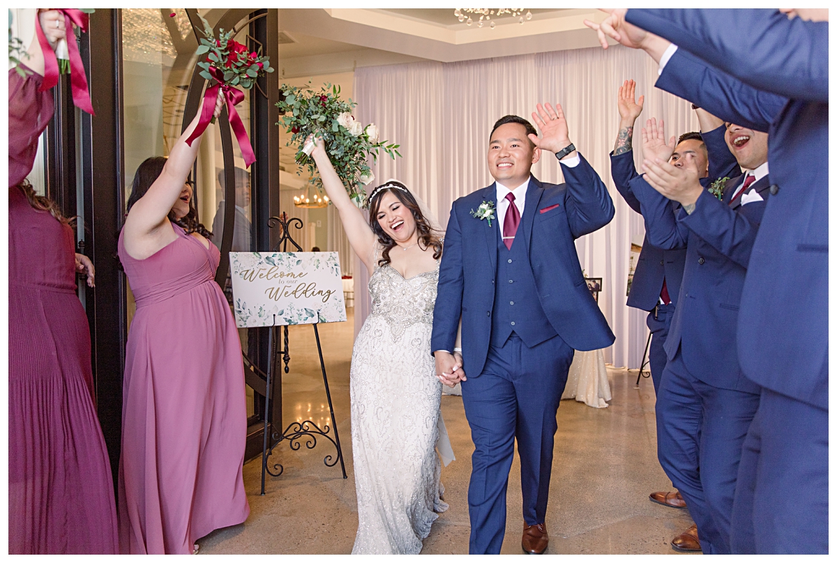 Bride and groom exits as bridal party cheers during Dallas Vietnamese wedding at Zander House photographed by Dallas wedding photographer Jenny Bui of Picture Bouquet Studio. 