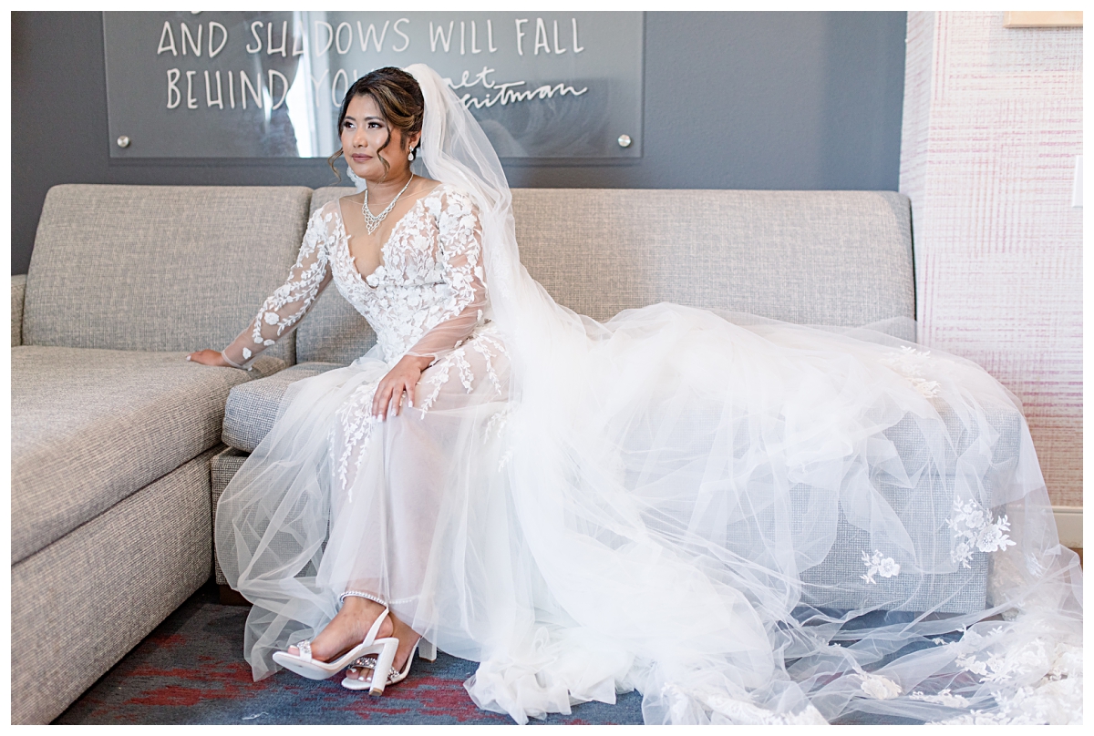 Gorgeous Asian bride in lace and tulle wedding dress poses for portraits during getting ready portion of wedding day photographed by Dallas wedding photographer Jenny Bui of Picture Bouquet Studio. 
