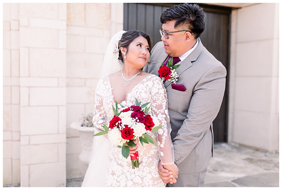 Bride and groom gazing at one another in front of Riverwalk Chapel for wedding portraits at Flowermound Riverwalk photographed by Dallas wedding photographer Jenny Bui of Picture Bouquet Studio. 