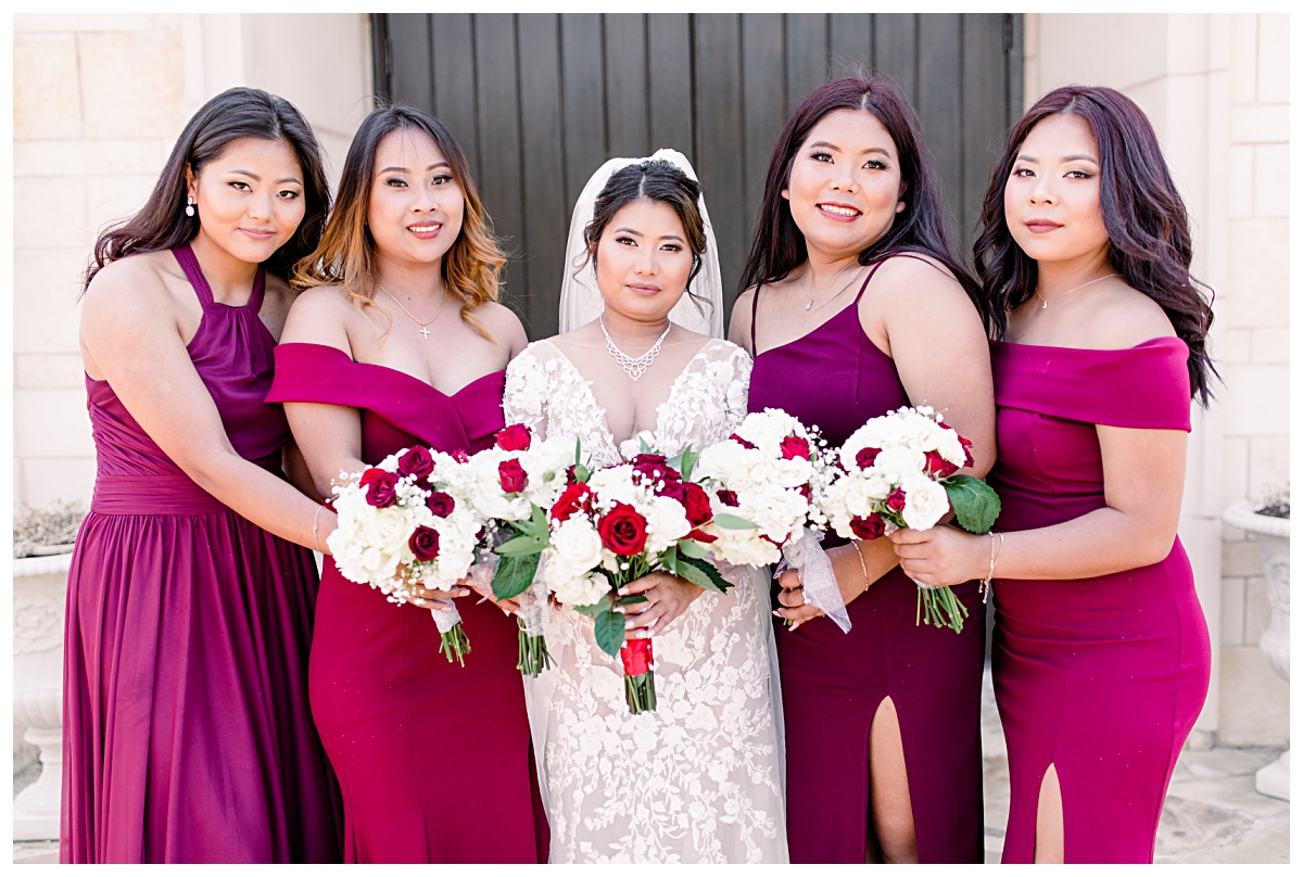 Bridesmaids in gorgeous burgundy floor length dresses poses with bride for wedding portraits at Flower Mound Riverwalk photographed by Dallas wedding photographer Jenny Bui of Picture Bouquet Studio. 