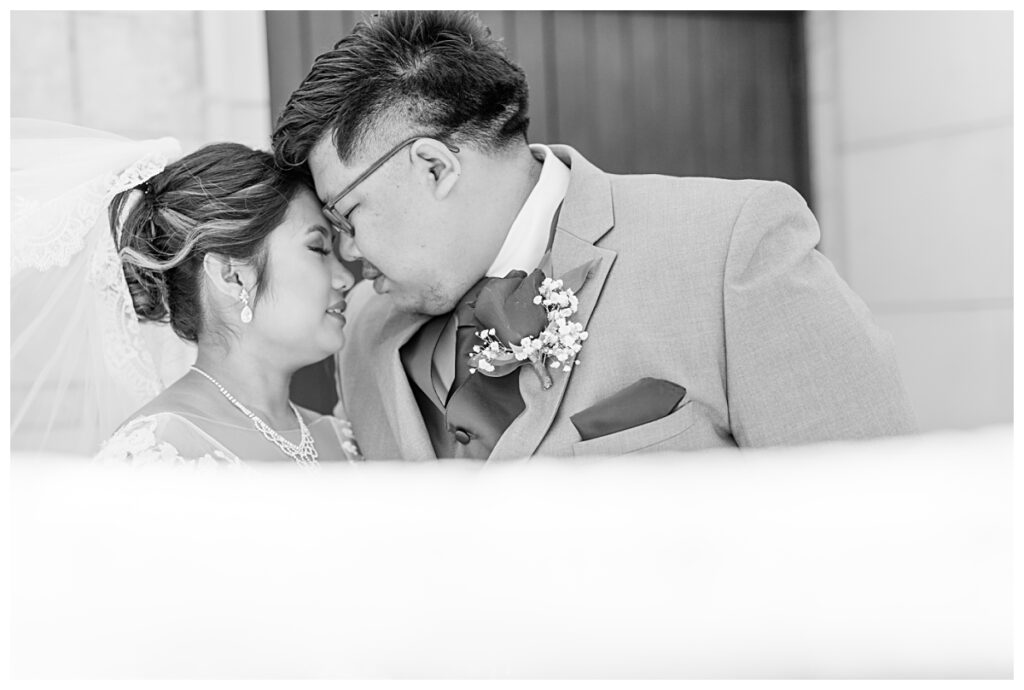 Black and white portrait of Asian bride and groom for wedding portraits at Flowermound Riverwalk photographed by Dallas wedding photographer Jenny Bui of Picture Bouquet Studio. 