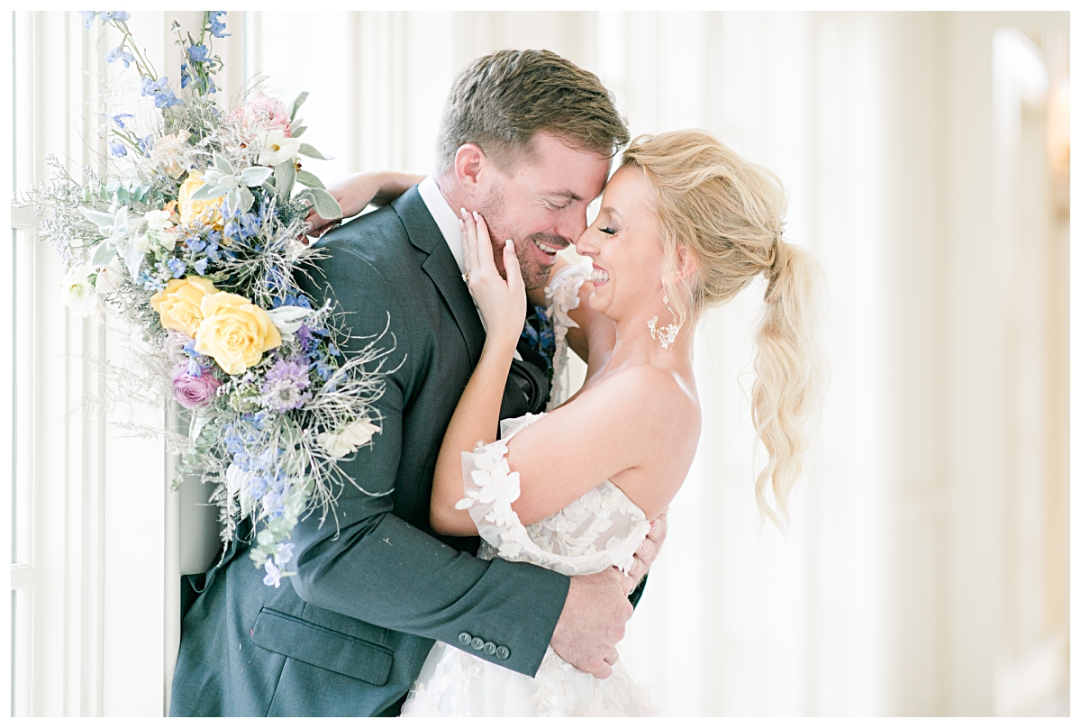 Bride and groom laughing as they hug the hallways of one of the best dallas wedding venue, The Olana, photographed by Jenny Bui of Picture Bouquet Studio. 