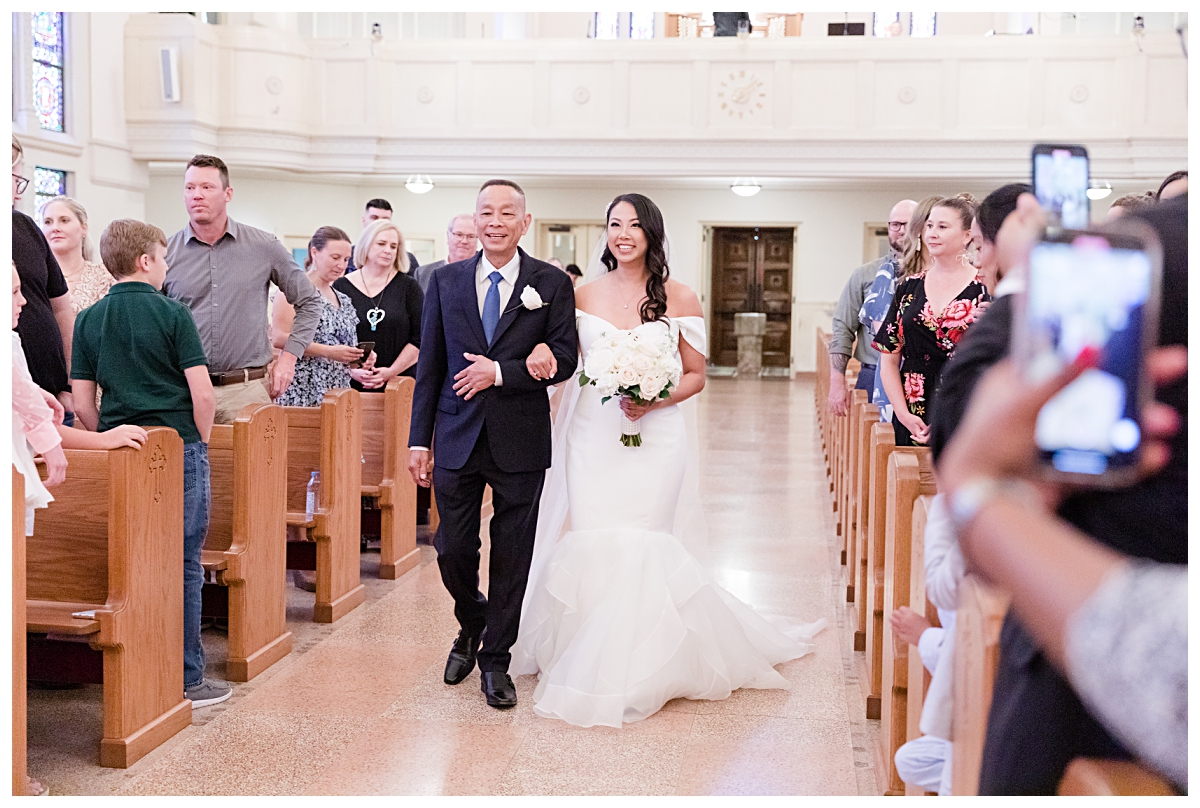 Beautiful bride and father walking down aisle photographed by Dallas wedding photographer Jenny Bui of Picture Bouquet Studio for Holy Trinity Catholic Church wedding in Dallas, TX.  