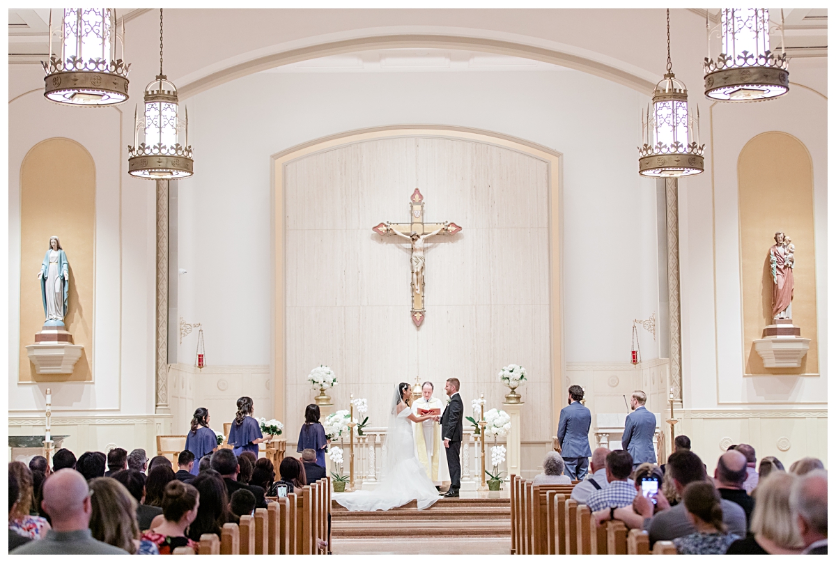 Bride and groom holding hands photographed by Dallas wedding photographer Jenny Bui of Picture Bouquet Studio for Holy Trinity Catholic Church wedding in Dallas, TX.  