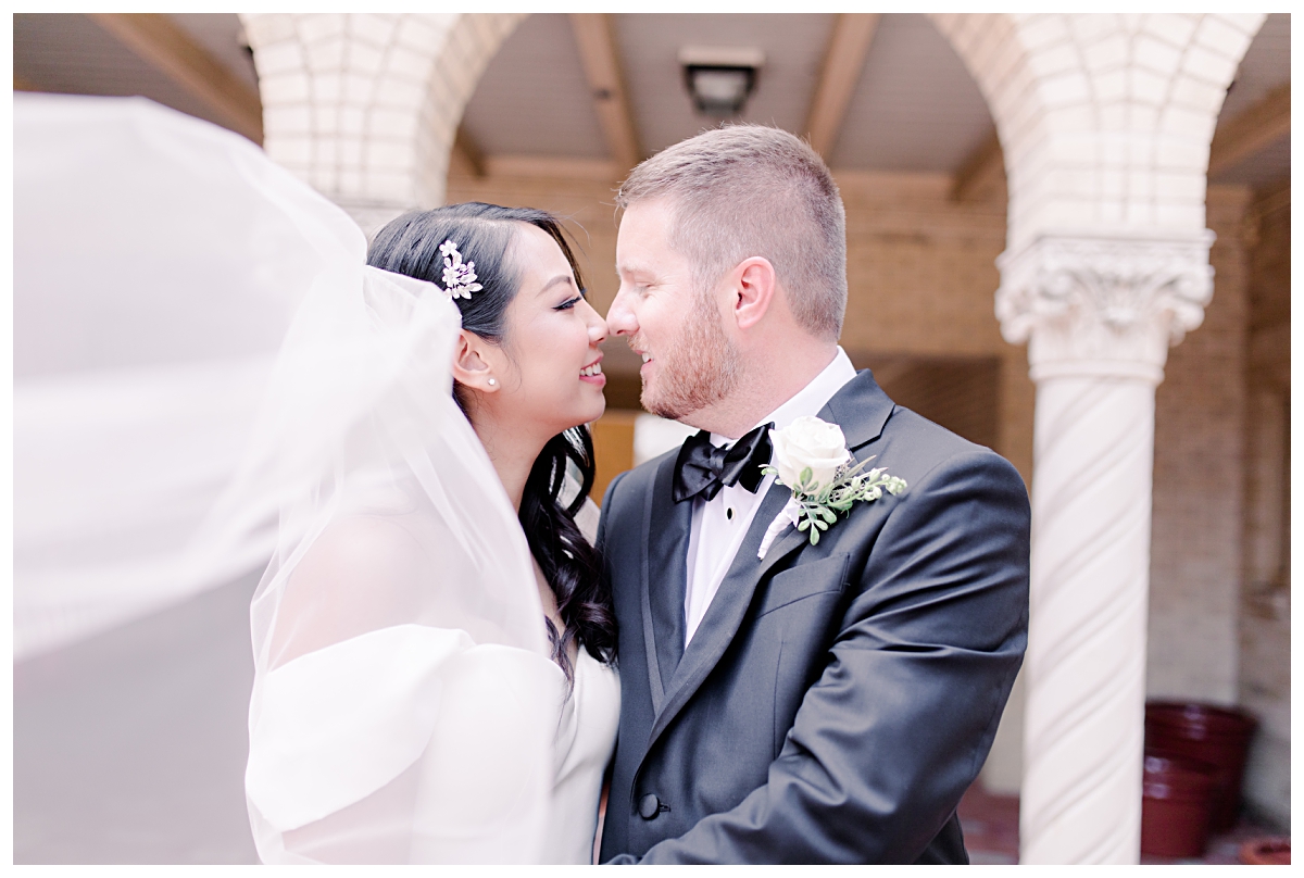 Gorgeous bride and groom nose to nose photographed by Dallas wedding photographer Jenny Bui of Picture Bouquet Studio for Holy Trinity Catholic Church wedding in Dallas, TX.  