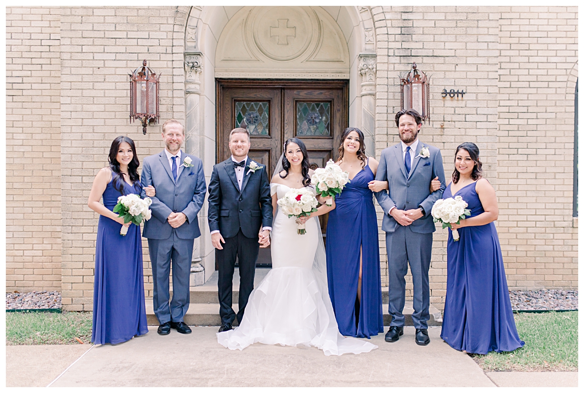 Bridal party photo of bridesmaids in royal blue and groomsmen in grey suits photographed by Dallas wedding photographer Jenny Bui of Picture Bouquet Studio for Holy Trinity Catholic Church wedding in Dallas, TX.  