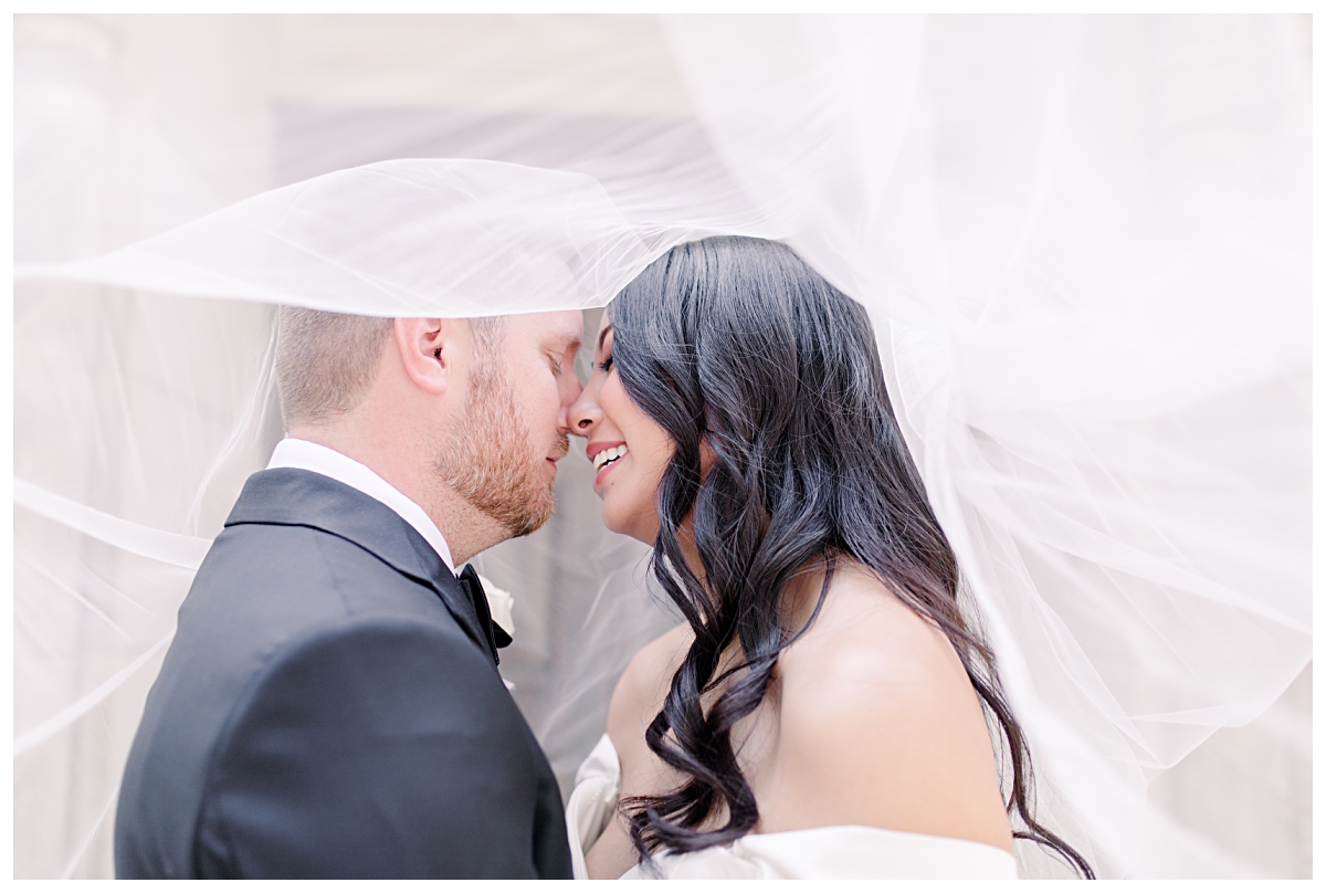 Beautiful, intimate shot of bride and groom beneath the veil photographed by Dallas wedding photographer Jenny Bui of Picture Bouquet Studio for Holy Trinity Catholic Church wedding in Dallas, TX.  
