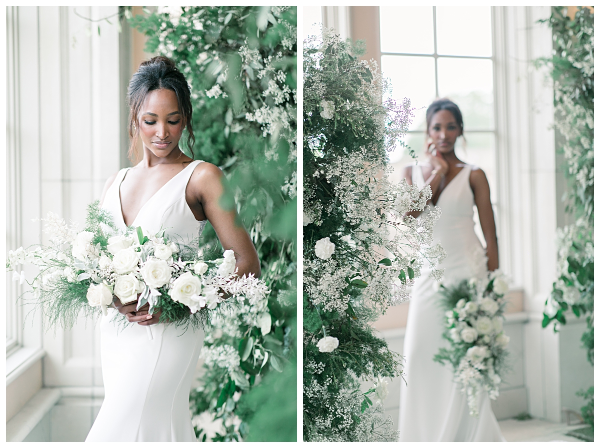 Bride in white wedding dress standing next to stunning white rose, baby breath, and greenery floral arrangement for editorial bridal shoot at The Olana pool room photographed by Dallas wedding photographer Jenny Bui of Picture Bouquet Studio. 