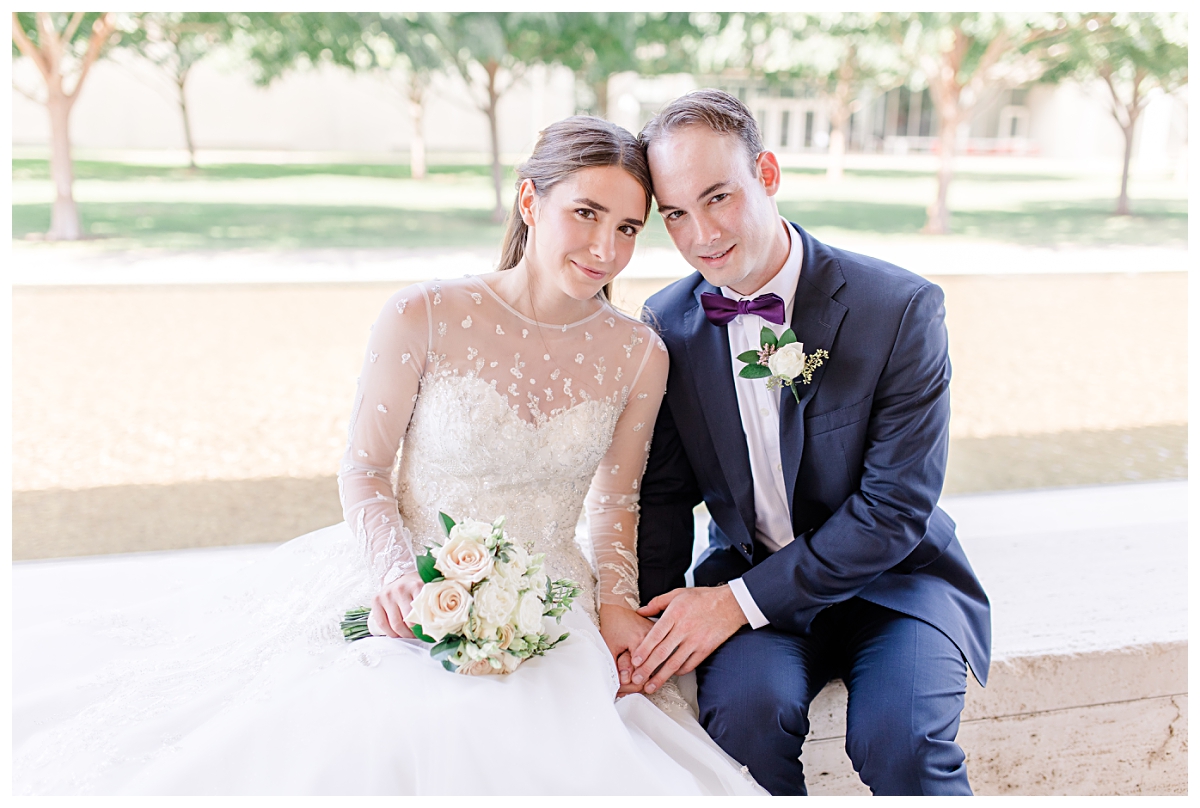 Bride in white long sleeve lace wedding dress smiling with groom in navy suit for Kimbell Art Museum wedding portraits photographed by Dallas wedding photographer Jenny Bui of Picture Bouquet Studio. 