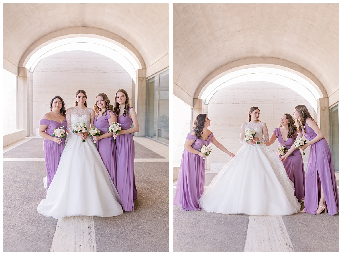 Beautiful bride in long sleeve lace wedding gown poses with bridesmaid in lilac dresses underneath archway at Kimbell Art Museum for wedding day portraits photographed by Jenny Bui of Picture Bouquet Studio. 